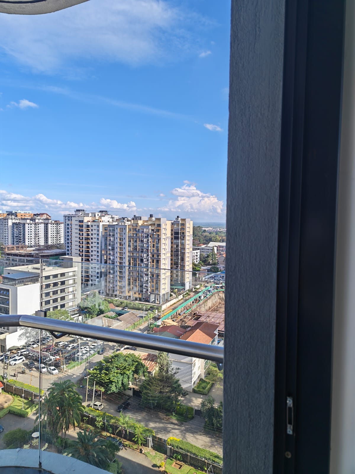 Panoramic Nairobi skyline view from a high-floor apartment at Oak Classic Residency looking toward Yaya Center.