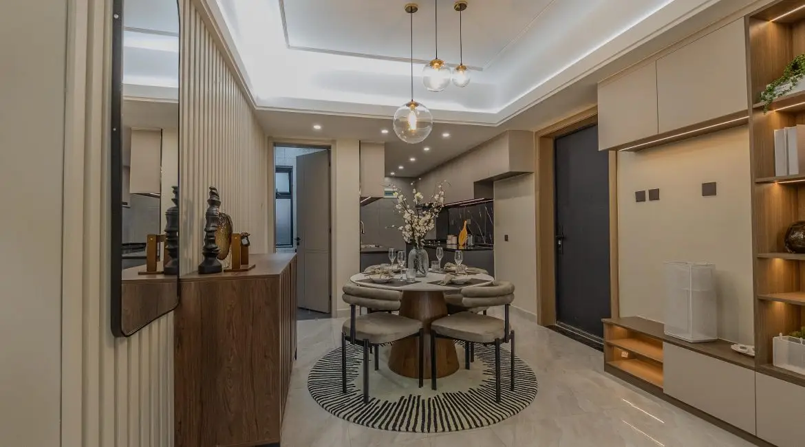 Modern apartment dining area adjoining the fitted kitchen at Oak West Residency