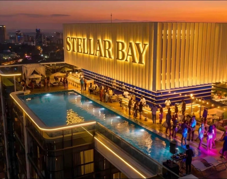 Rooftop pool and entertainment area at Stellar Bay Westlands at night