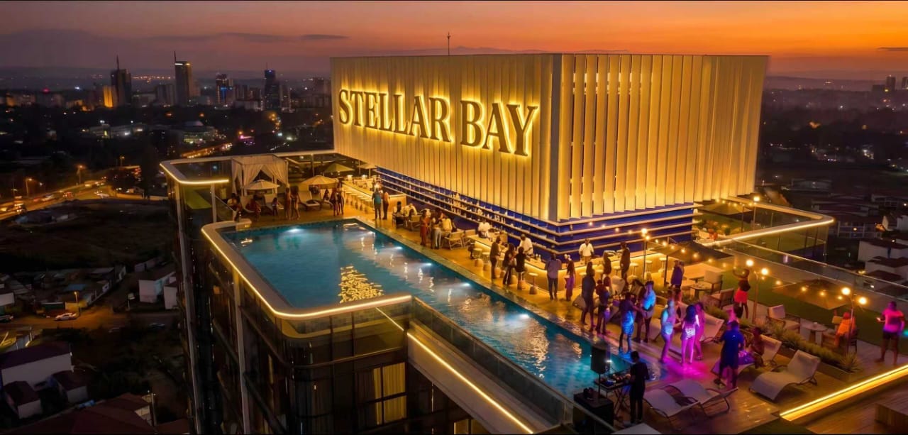 Rooftop pool and entertainment area at Stellar Bay Westlands at night