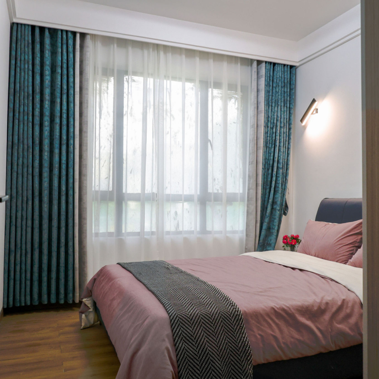 Bright bedroom with large window in a 1 bedroom apartment in Kilimani