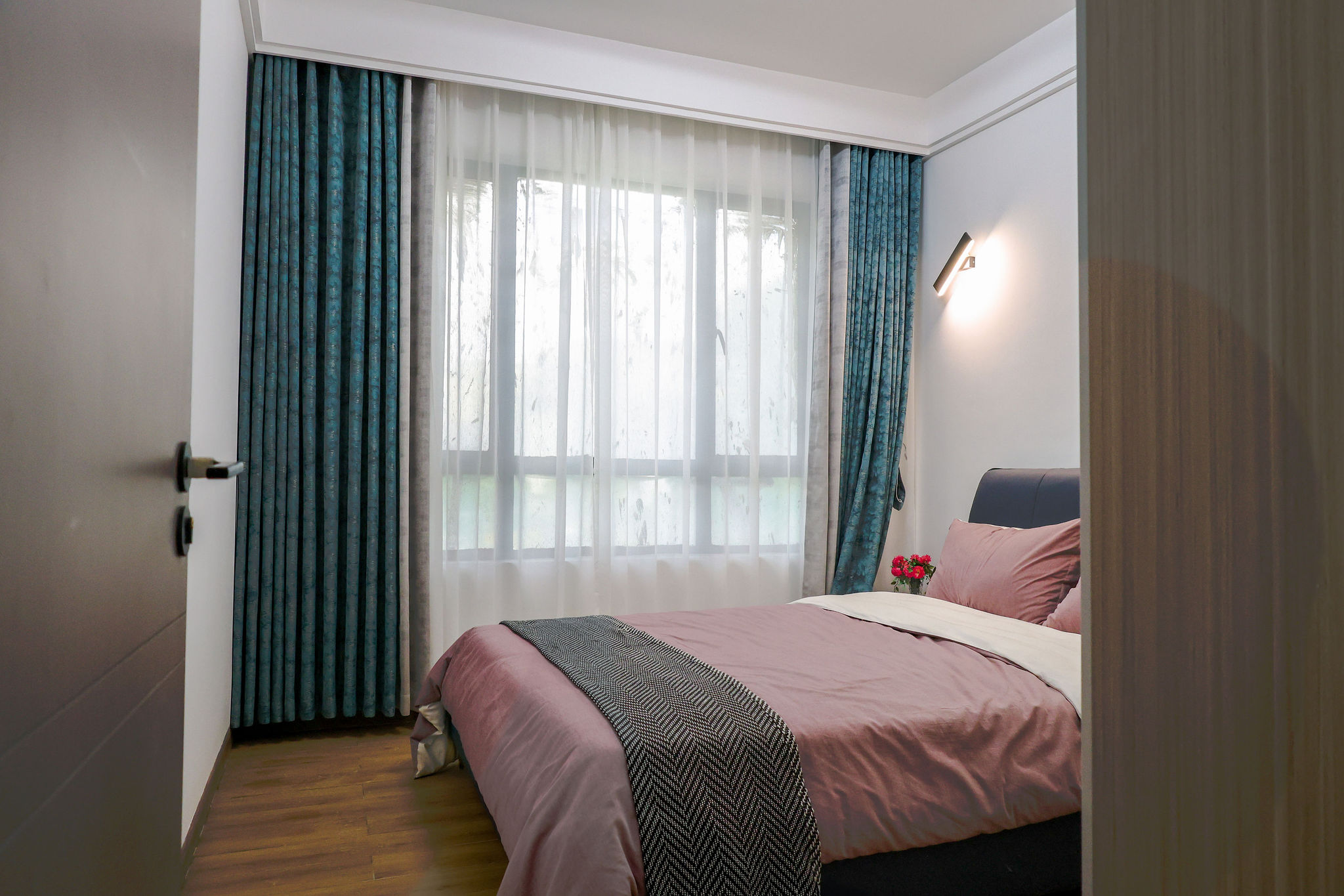 Bright bedroom with large window in a 1 bedroom apartment in Kilimani