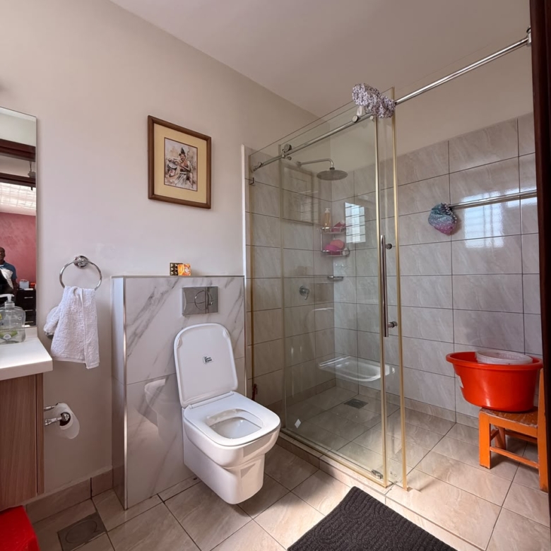 Bathroom with glass-enclosed shower at Convent Oaks Lavington townhouse
