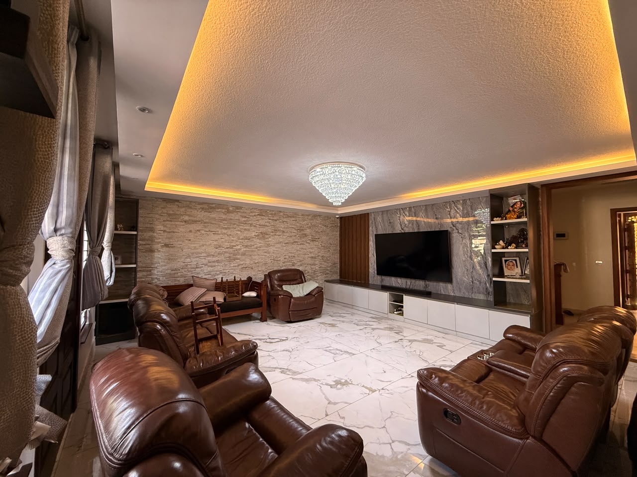 Family lounge with fitted entertainment wall at Convent Oaks Lavington