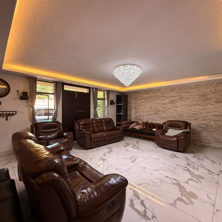 Spacious family lounge with leather seating at Convent Oaks Lavington