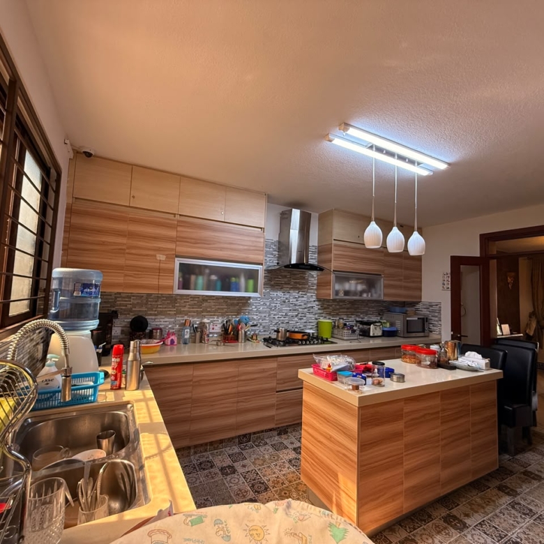 Modern fitted kitchen with central island at Convent Oaks Lavington