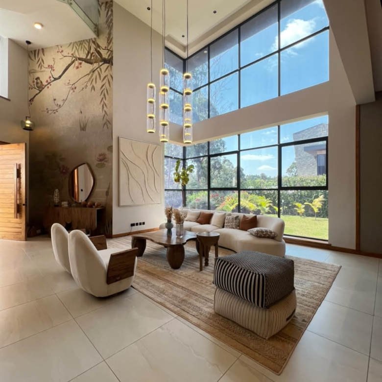 Luxury double-height lounge with large windows in a Loresho villa