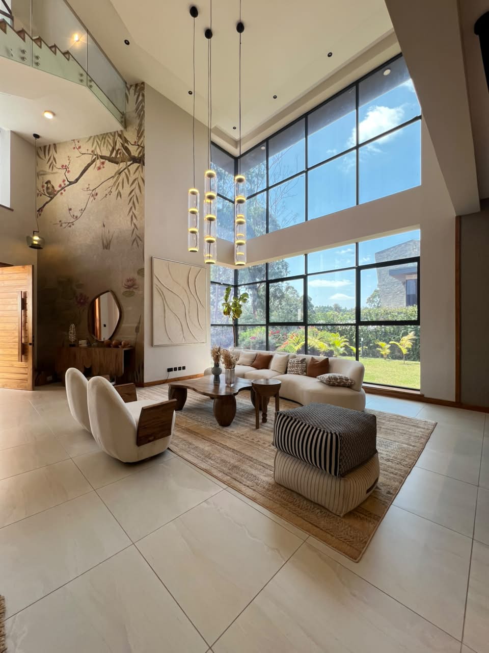 Luxury double-height lounge with large windows in a Loresho villa