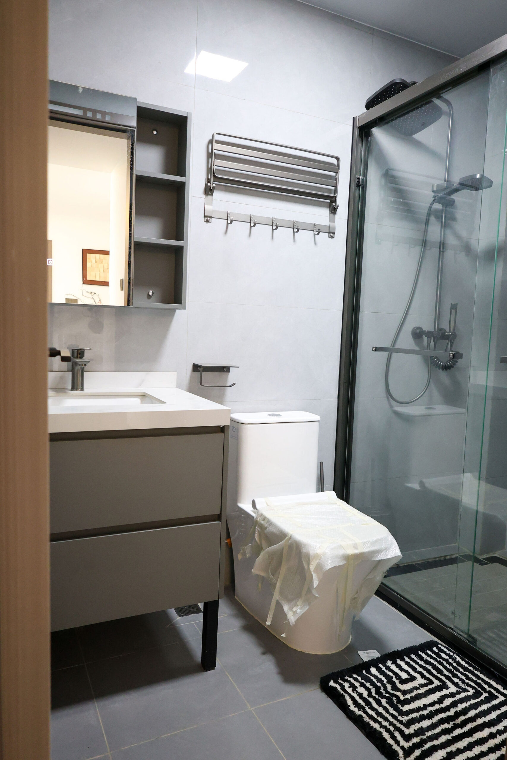 Modern bathroom with glass shower in a 1 bedroom apartment in Kilimani