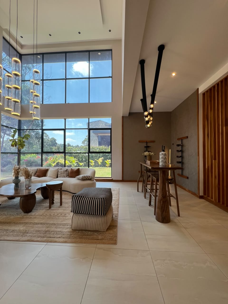 Double-height living room in an Oak and Ivy villa in Loresho
