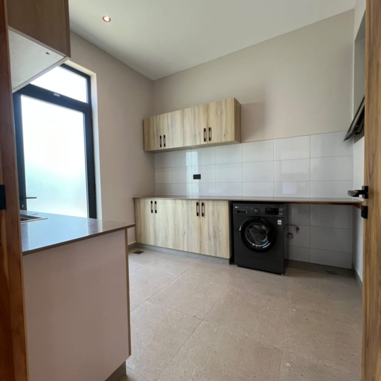 Fitted laundry and utility room in an Oak and Ivy villa in Loresho