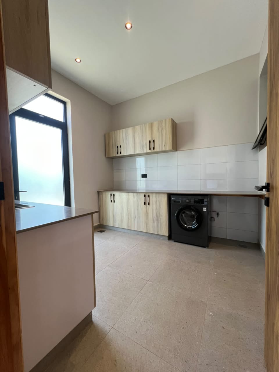 Fitted laundry and utility room in an Oak and Ivy villa in Loresho