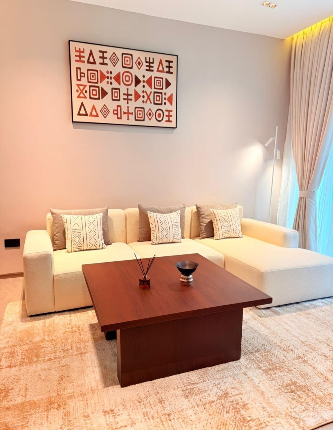 Bright furnished living room with sectional sofa at Silva Gigiri