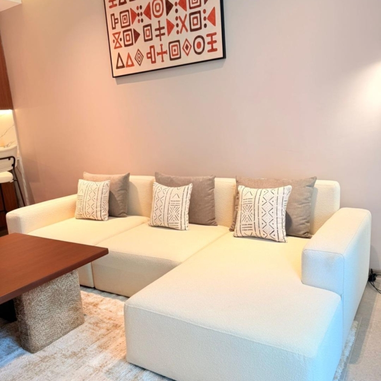 Cream sectional sofa and African artwork at Silva Gigiri apartments