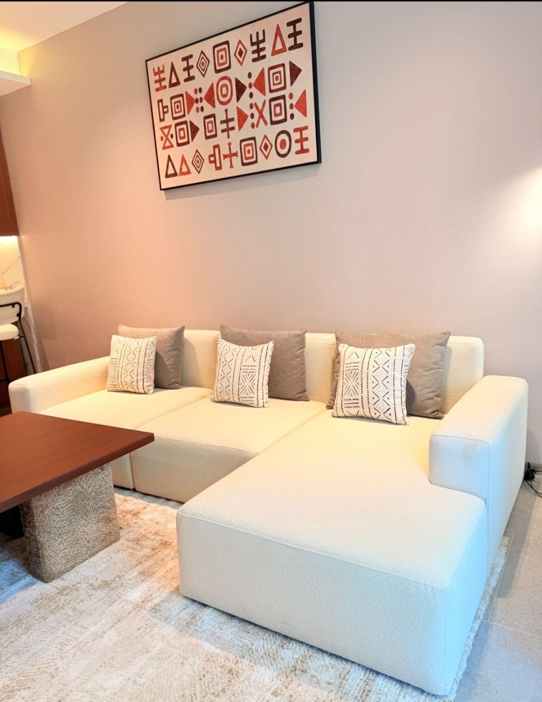 Cream sectional sofa and African artwork at Silva Gigiri apartments