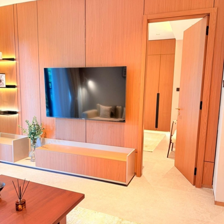 Wood-panelled living room with mounted television at Silva Gigiri