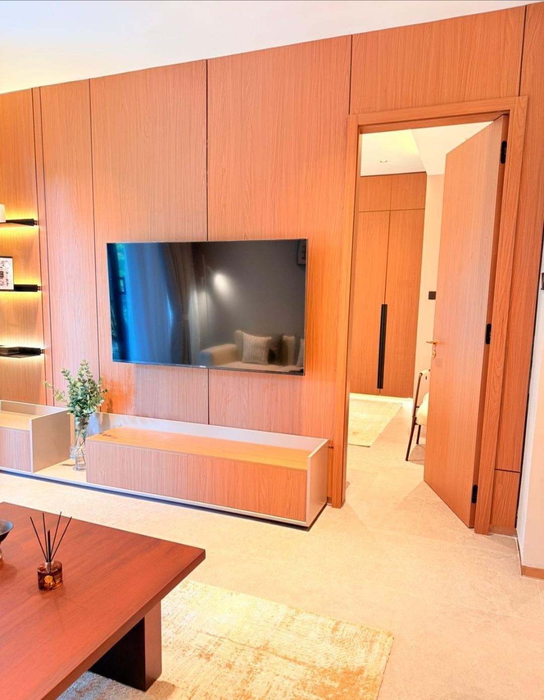 Wood-panelled living room with mounted television at Silva Gigiri