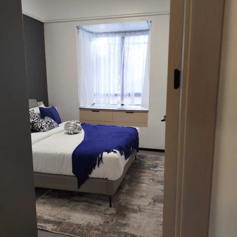 Furnished bedroom with blue accent bedding in a Westlands 2 bedroom apartment