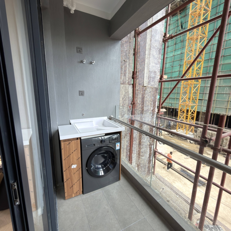 Balcony laundry area with washing machine in a Westlands apartment