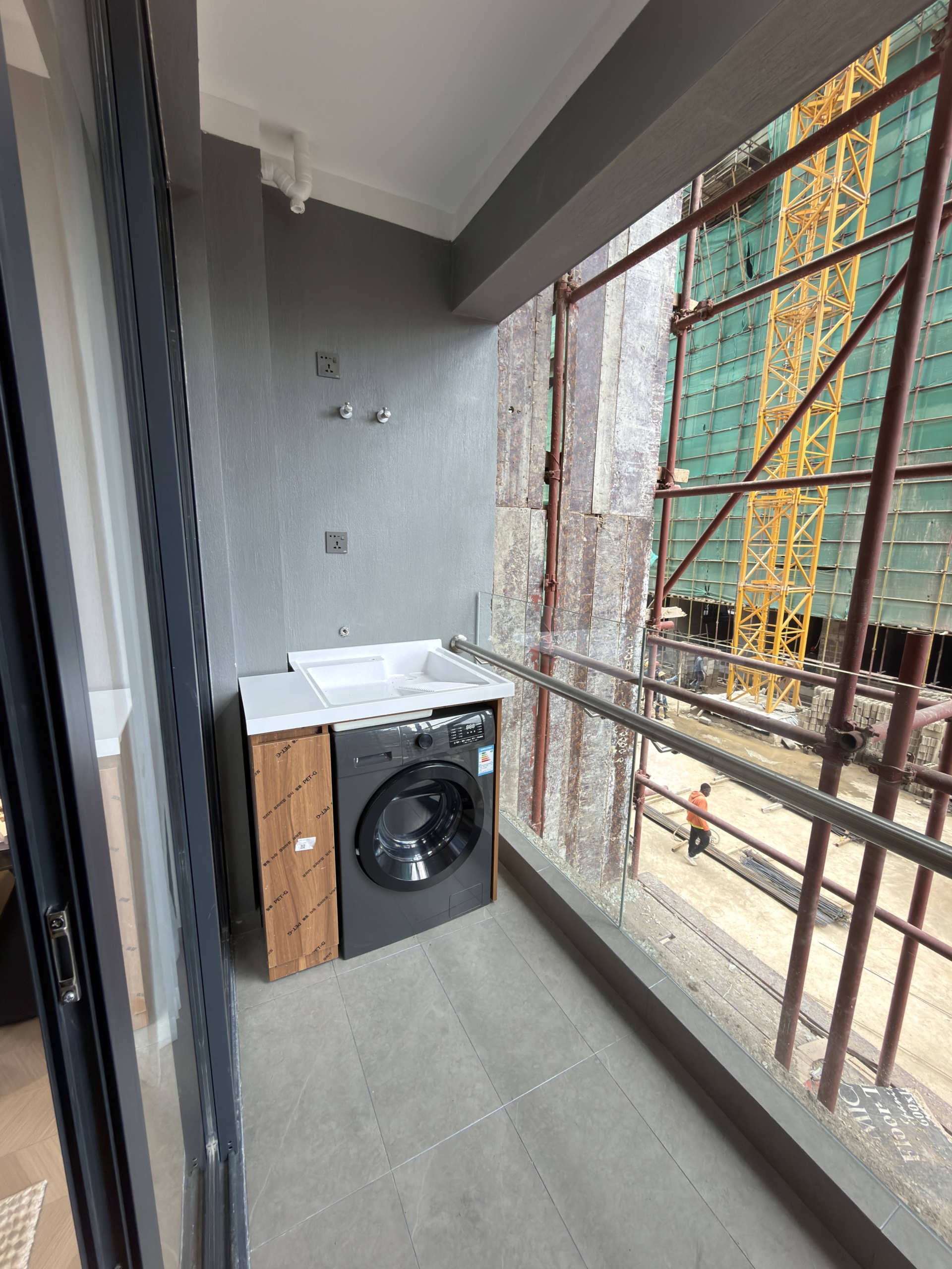 Balcony laundry area with washing machine in a Westlands apartment