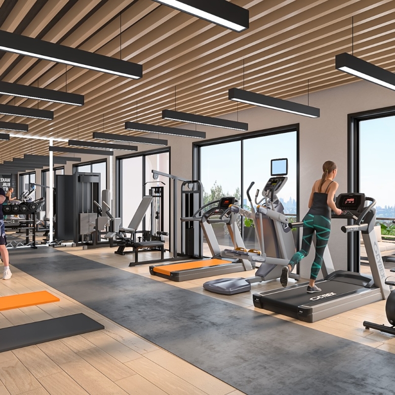 Baystar residence fully equipped gym with treadmills, exercise bikes, weight machines, dumbbells and large windows.