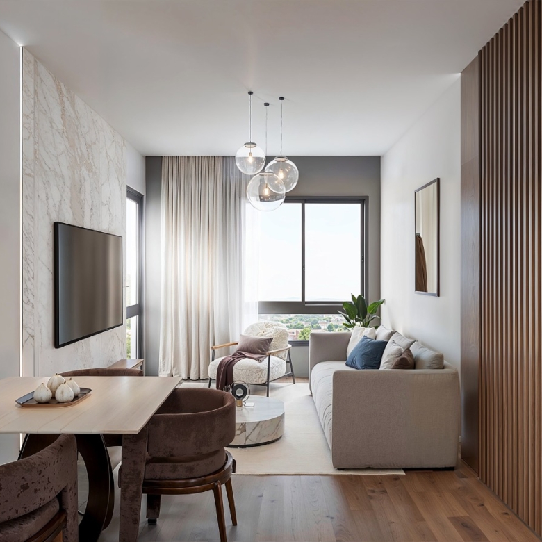 Baystar residence contemporary living room with comfortable sofa, dining table, modern pendant lights and large windows.