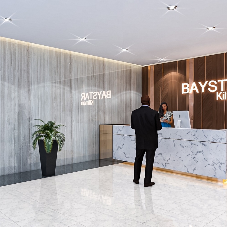 Baystar residence reception lobby in Kilimani featuring marble reception desk, modern lighting, wooden wall panels and elegant finishes.