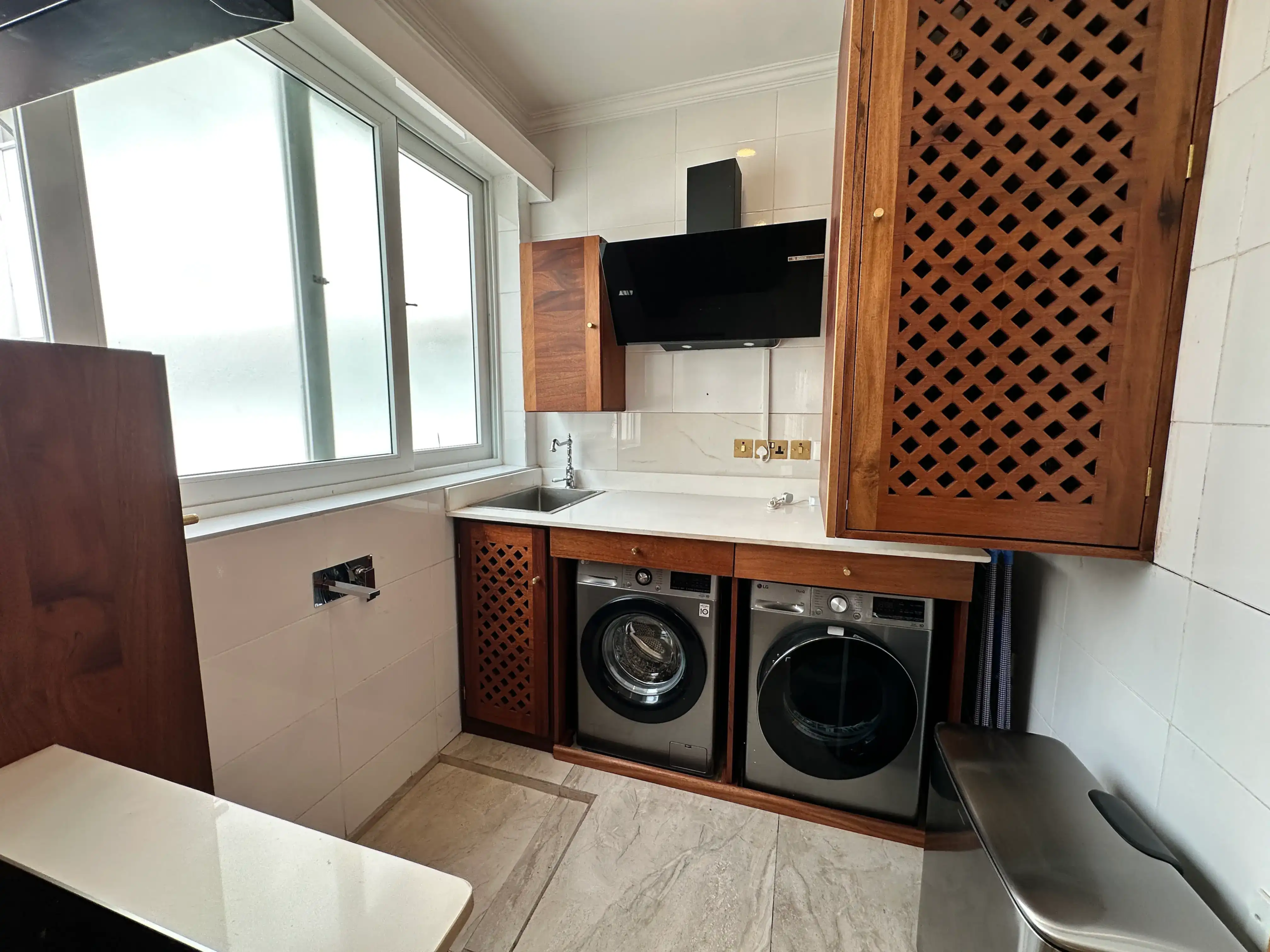 Utility room with washing machine, dryer and storage cabinets