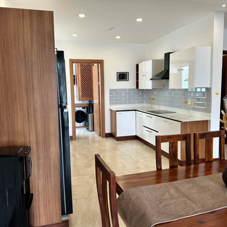 Modern kitchen viewed from the furnished dining area