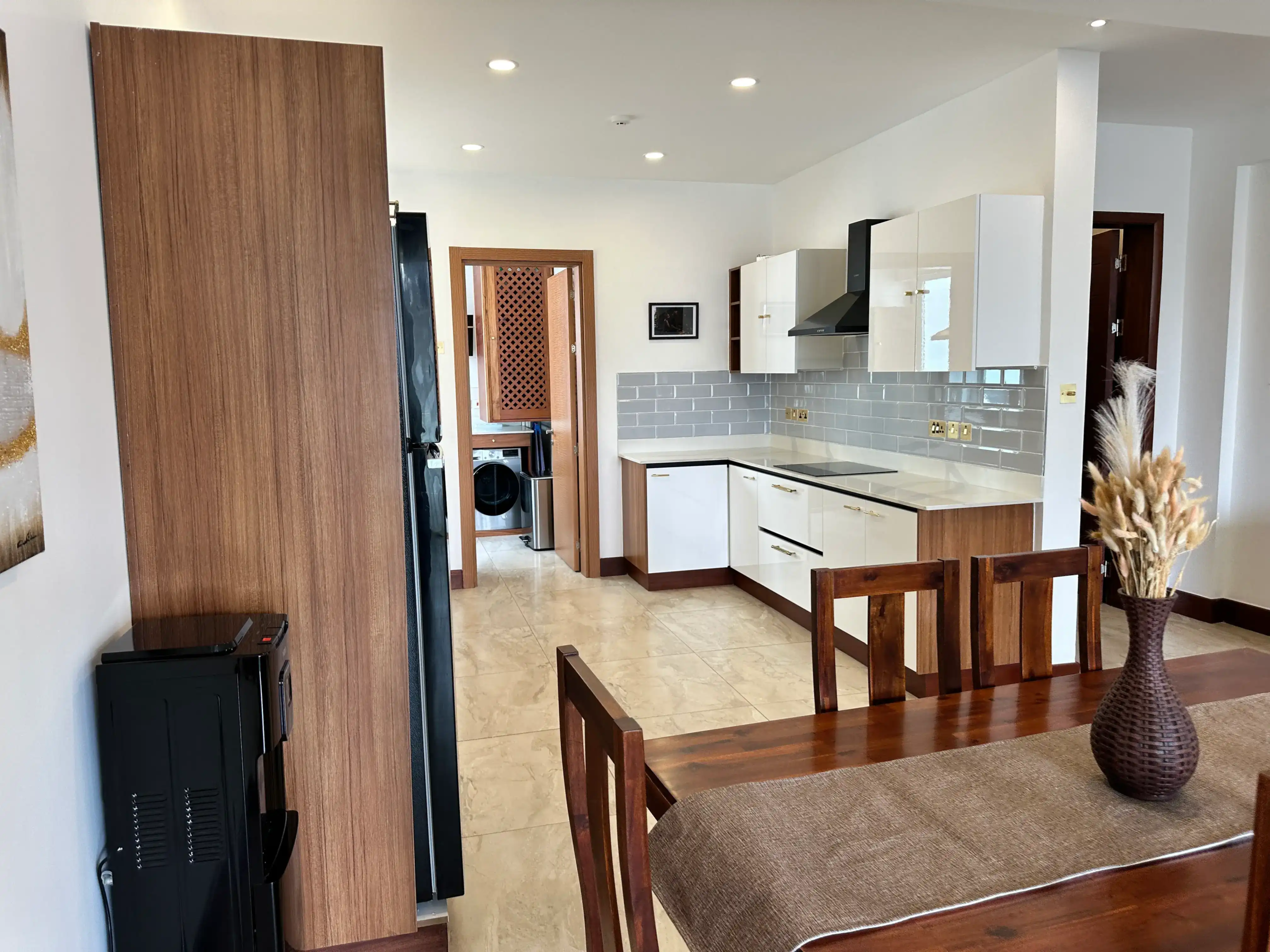 Modern kitchen viewed from the furnished dining area