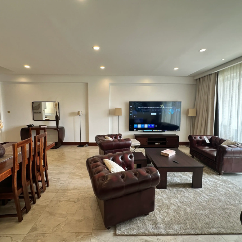 Furnished living room with large windows and balcony access