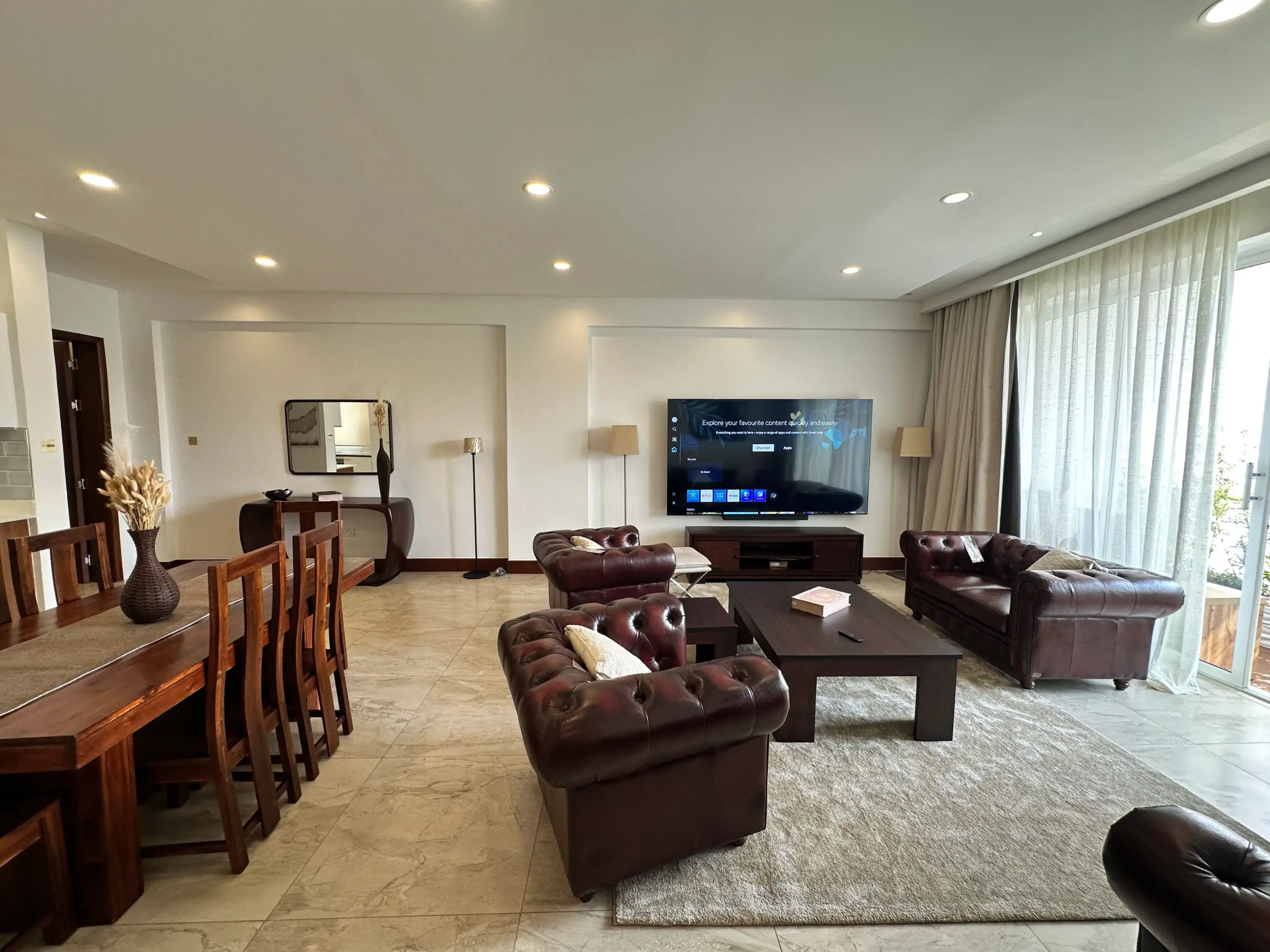Furnished living room with large windows and balcony access