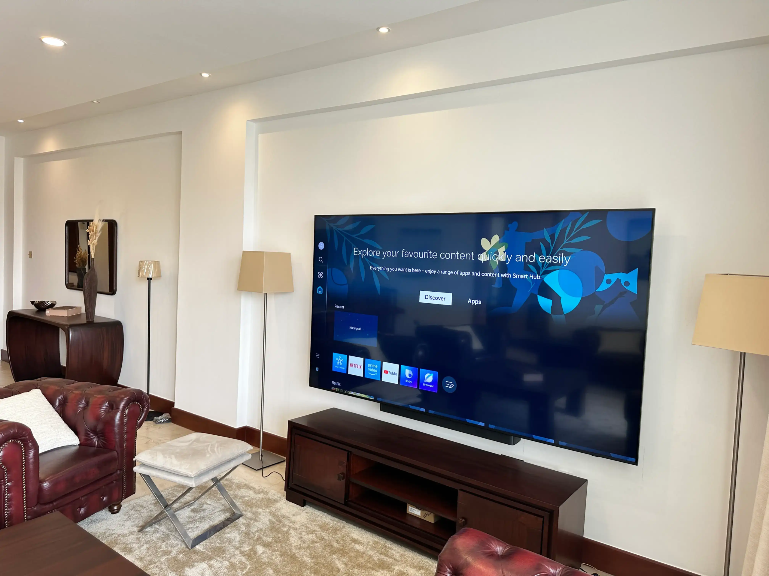 Large wall-mounted television in a furnished living room