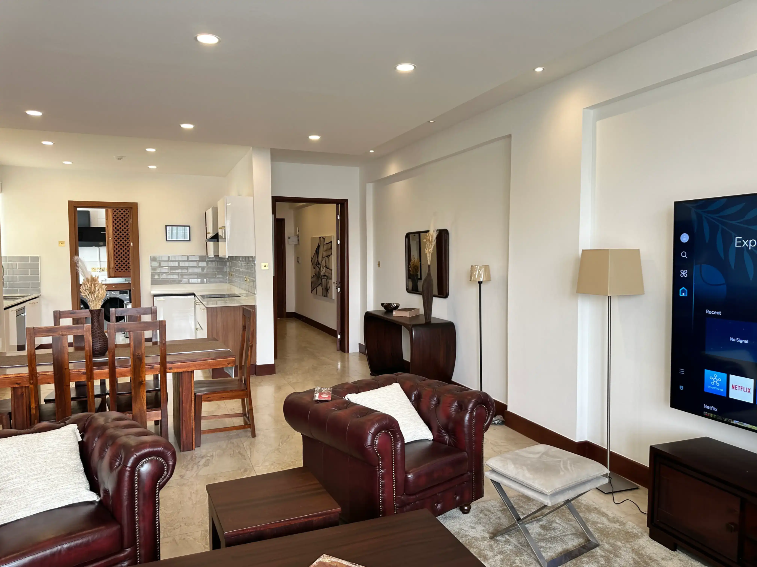 Leather lounge seating overlooking the dining area and kitchen