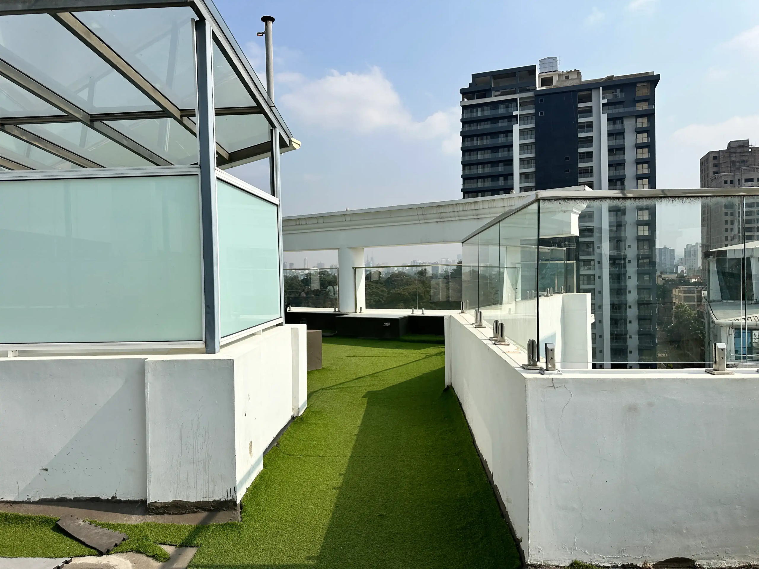 Rooftop walking track with glass railings and Nairobi views
