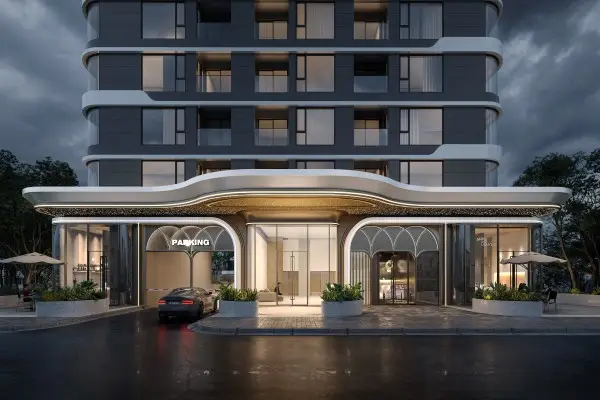 Modern high-rise exterior of Golden Apple Residence at night