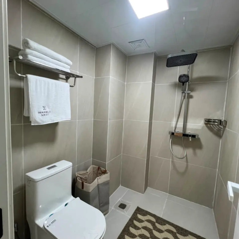 Modern bathroom with walk-in shower at Marble West Apartments
