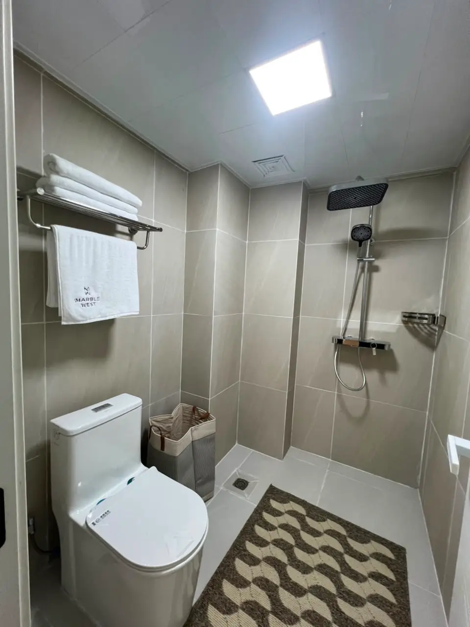 Modern bathroom with walk-in shower at Marble West Apartments