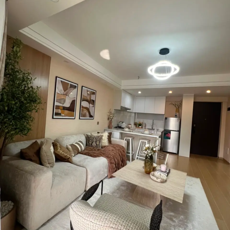 Furnished open-plan living room and kitchen at Marble West Apartments