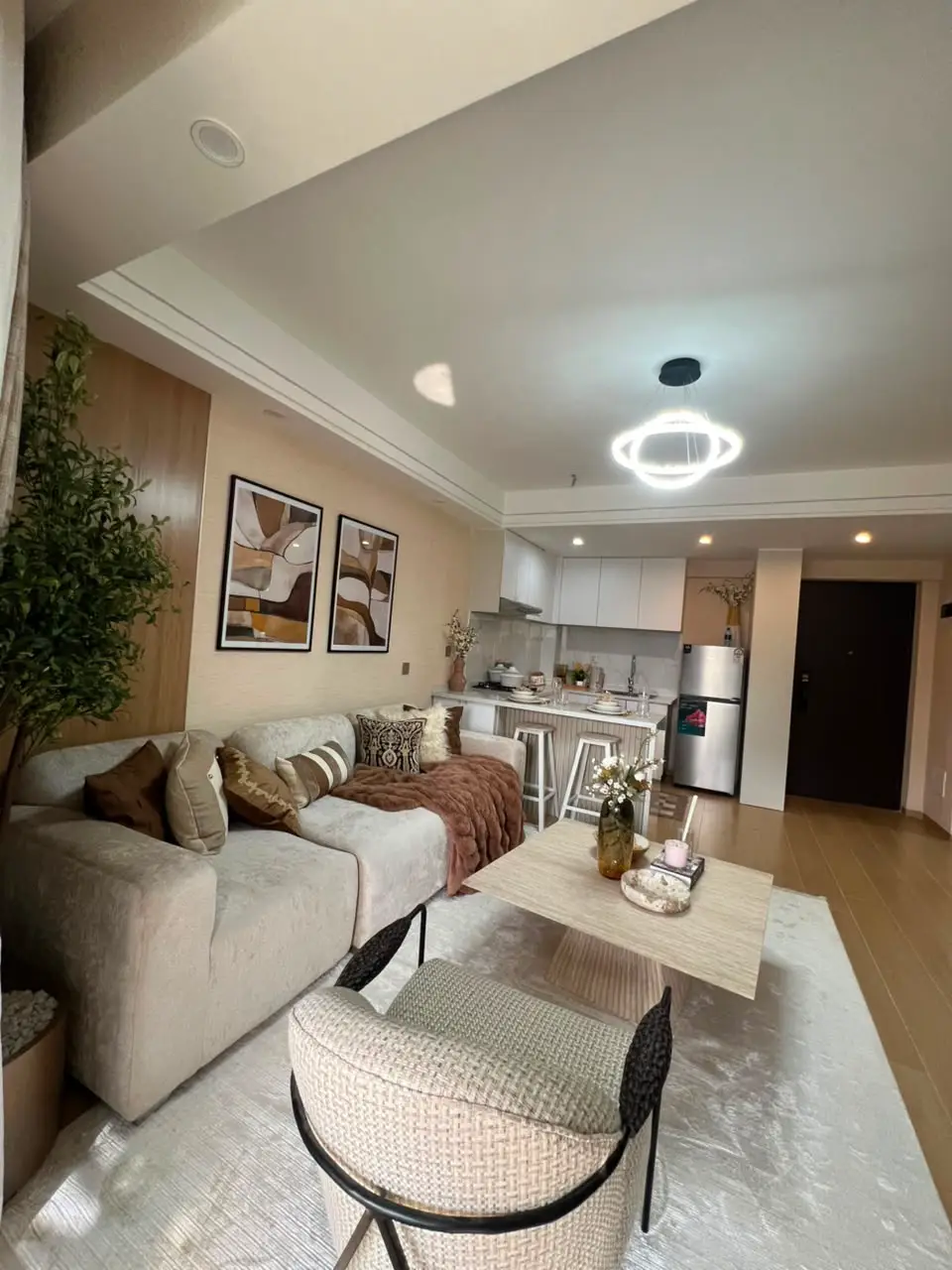Furnished open-plan living room and kitchen at Marble West Apartments