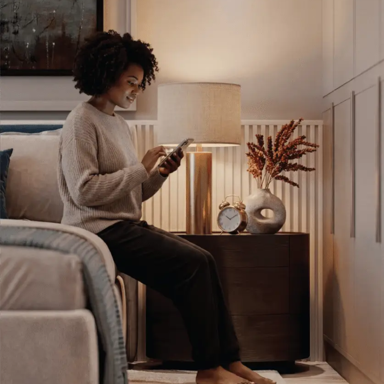 Woman using a smartphone in a modern Melody Towers bedroom
