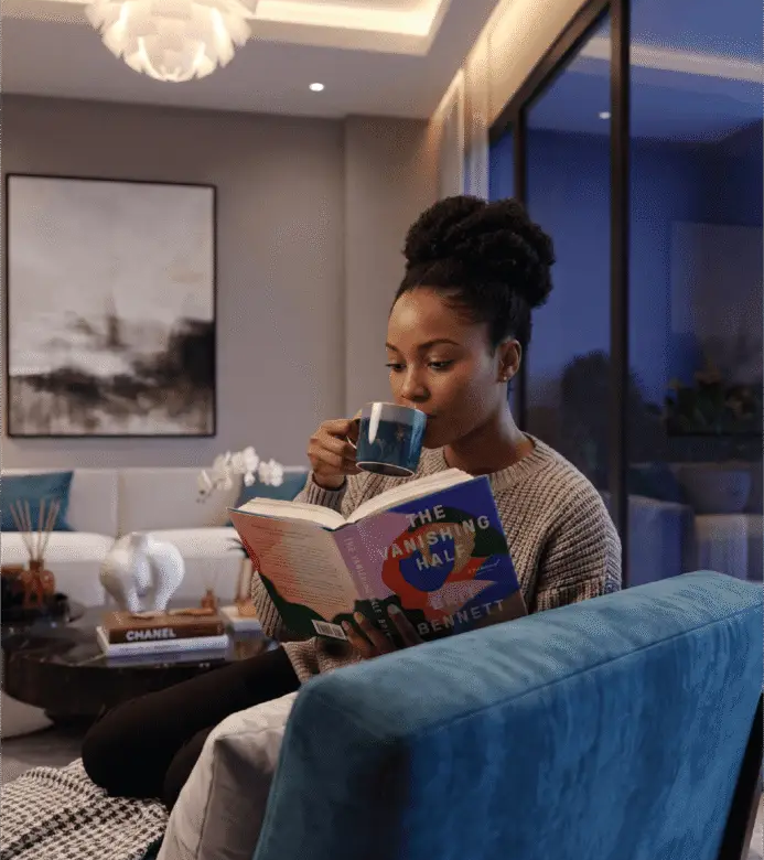 Woman relaxing in a modern Melody Towers apartment living room