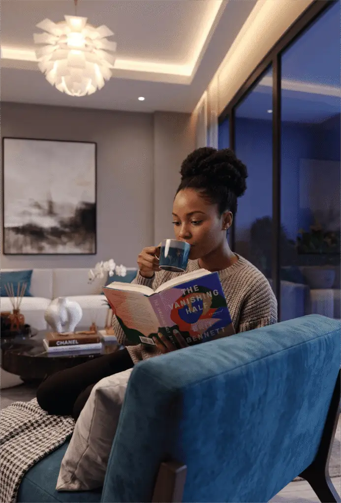 Woman relaxing in a modern Melody Towers apartment living room