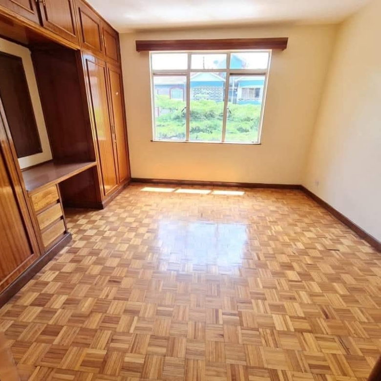 Spacious bedroom with fitted wooden wardrobes in a serviced 4 bedroom apartment for rent on Riverside Drive