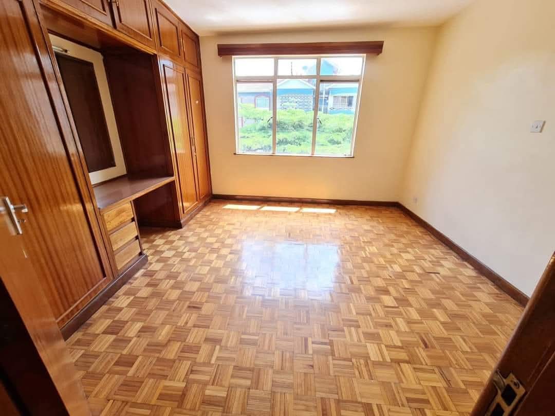 Spacious bedroom with fitted wooden wardrobes in a serviced 4 bedroom apartment for rent on Riverside Drive