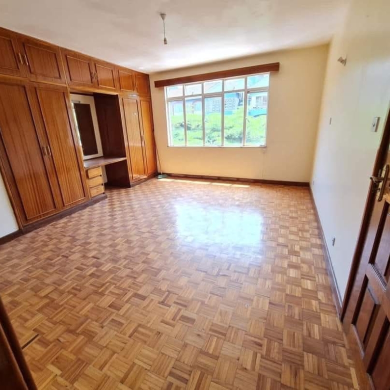 Bright bedroom with built-in wardrobes and parquet flooring in a Riverside Drive apartment