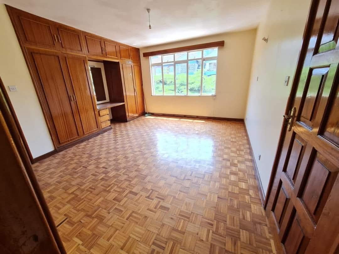 Bright bedroom with built-in wardrobes and parquet flooring in a Riverside Drive apartment