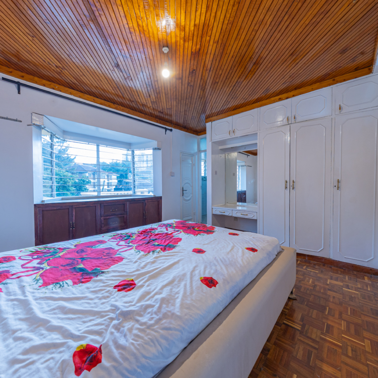 Master bedroom with fitted wardrobes in Oloitoktok Court townhouse Kileleshwa