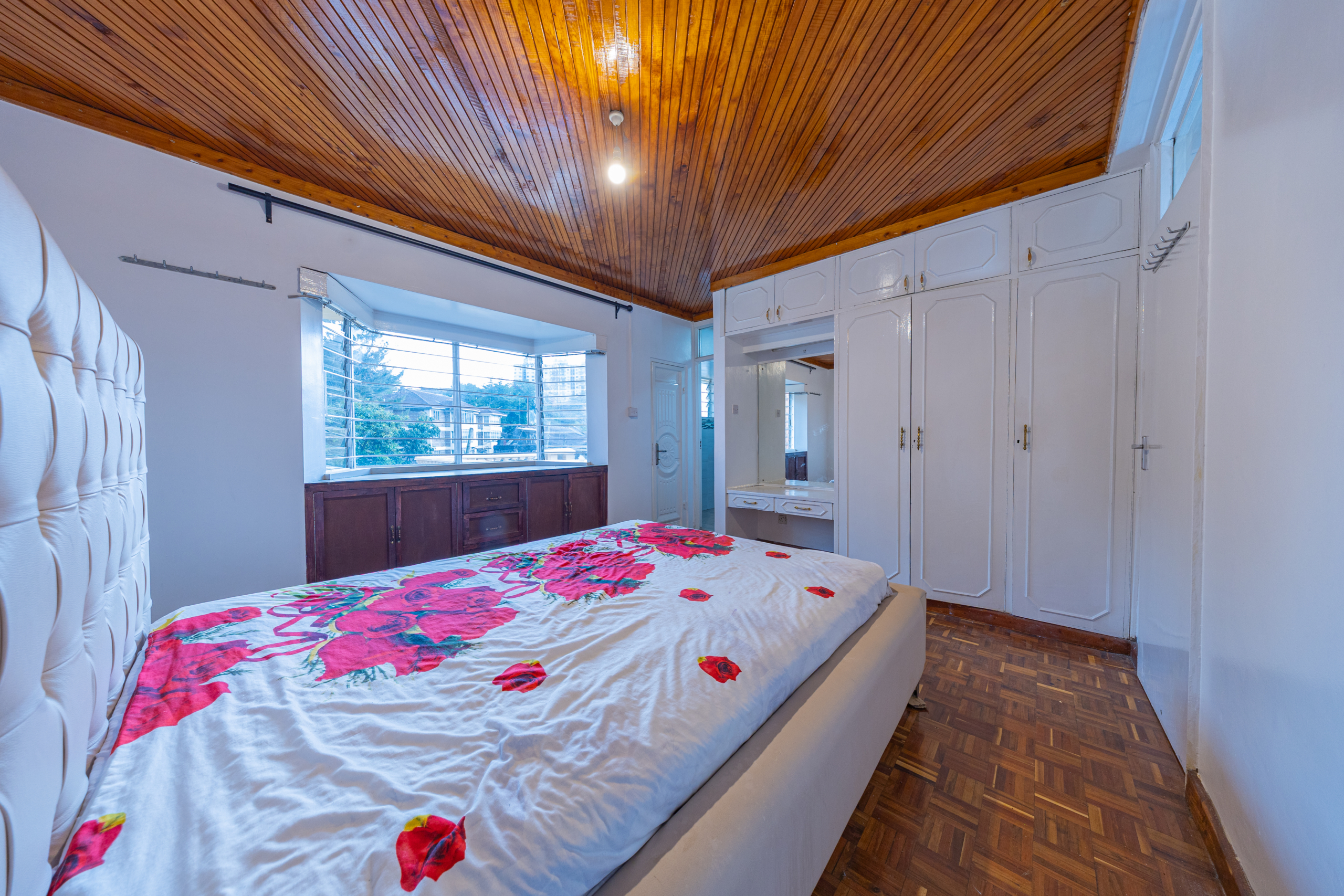Master bedroom with fitted wardrobes in Oloitoktok Court townhouse Kileleshwa