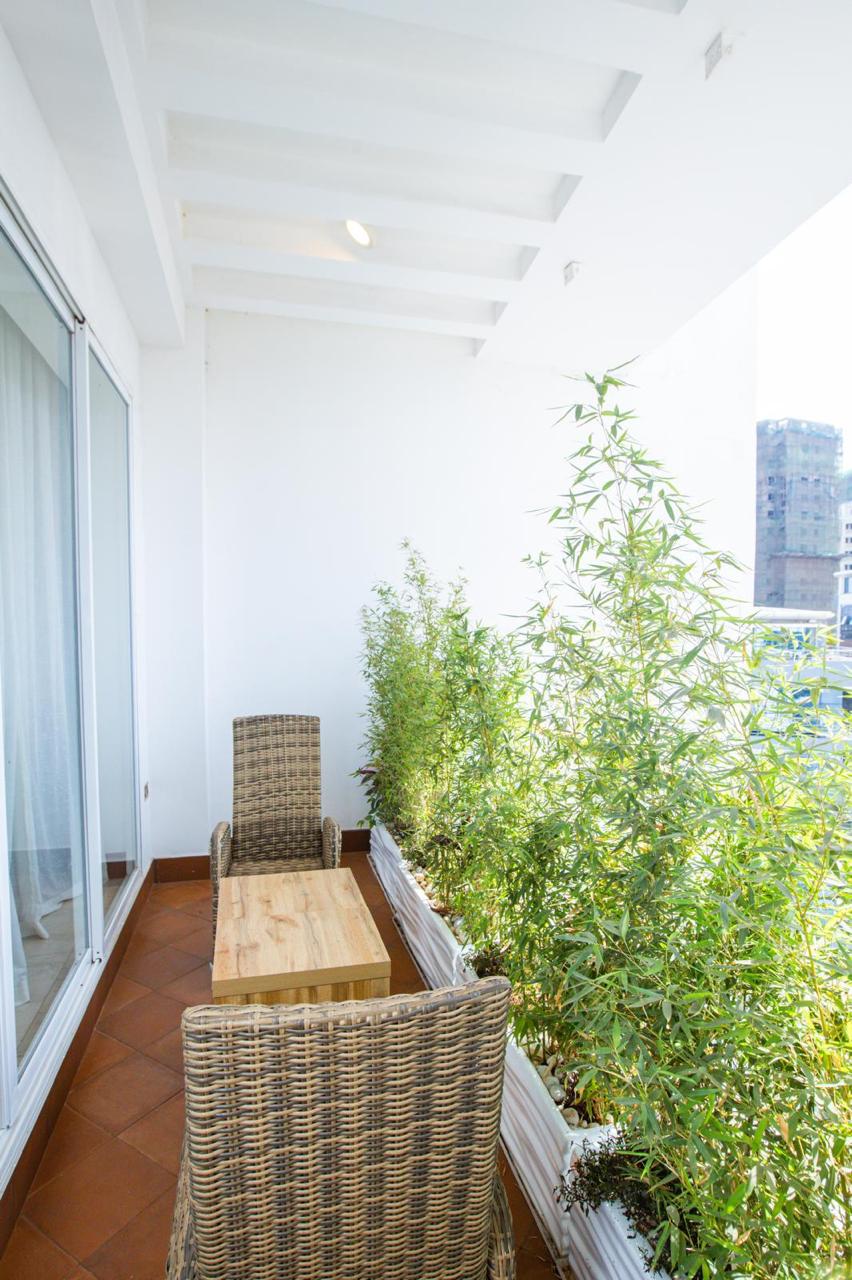 Furnished private balcony with seating and greenery in a serviced Parklands apartment